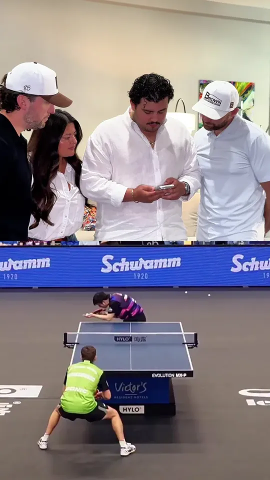 Spectators courtside at a table tennis match
