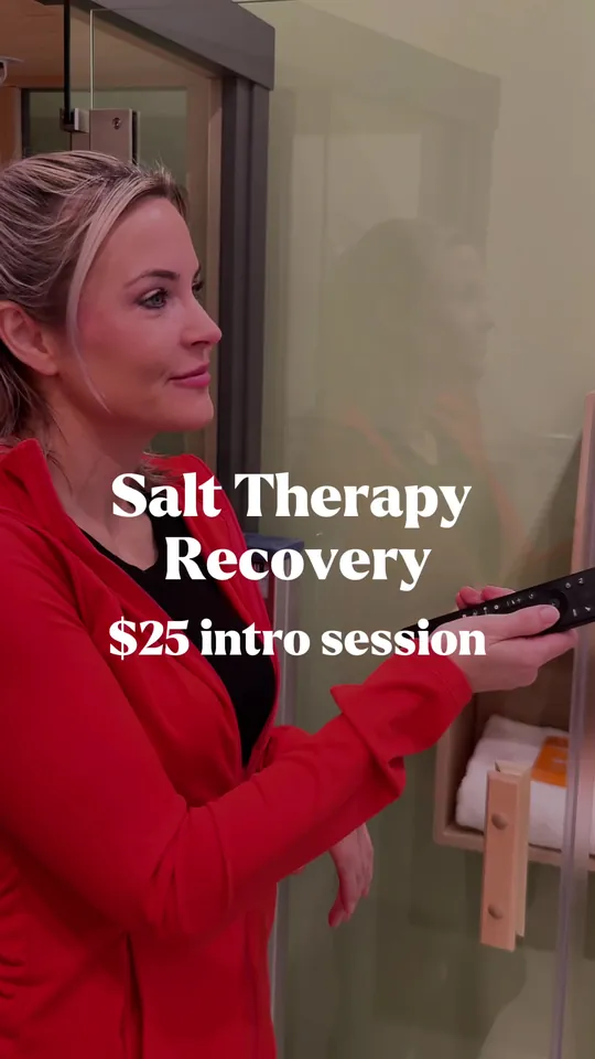 A woman beside a salt therapy room, captioned Salt Therapy Recovery, $25 intro session
