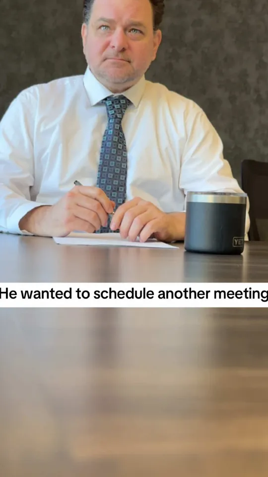 A man in a shirt and tie at a desk, captioned He wanted to schedule another meeting