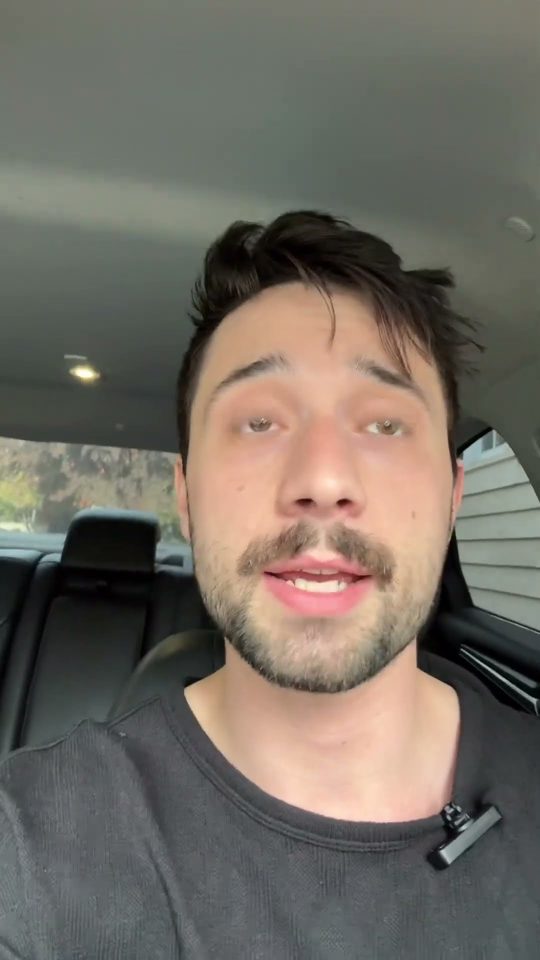 Morgan filming a selfie video in the back seat of a car